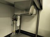 a sink in the corner of a bathroom with a metal faucet