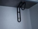 a pair of scissors hanging from a shelf in a room