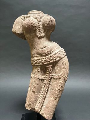 a stone statue of a woman with a dress on her head