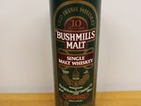 bushmills malt single malt whisky in a tall glass on a wooden table