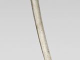 a close up of a knife with a gold handle on a white background