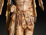 a statue of jesus on the cross with blood on his face