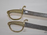 two swords that are on display on a table