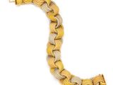 a close up of a yellow and white bracelet on a white background