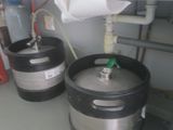 two kegs sitting next to each other in a room