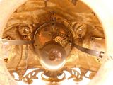 a close up view of a gold clock with a white background