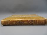 an old book sitting on top of a white table