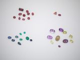 a group of different colored gems on a white surface