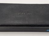 an old black leather case with a blue button on it
