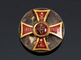 an image of a gold and red cross broochle