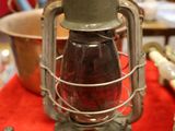 a lantern on a table with other items on the table