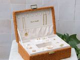 a jewelry box sitting on top of a table next to a potted plant