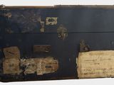 an old suitcase that has a lot of writing on it