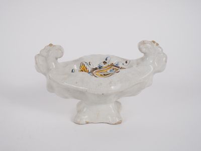 a white bowl with a dragon on it on a white surface