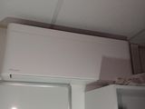 a refrigerator with a freezer on top of it in a kitchen