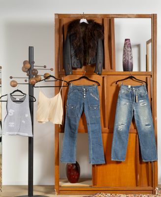 deux paires de jeans suspendues à un portant dans une pièce