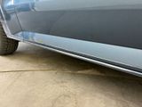 a close up of a blue truck parked in a garage