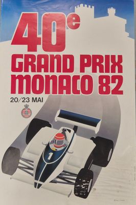 a close up of a poster of a racing car on a table