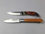 pair of knives on a table with a white table cloth