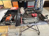 a table with tools and tools on it in a garage