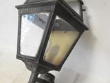 an old fashioned light fixture mounted on a wall next to a white wall