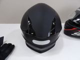a helmet and gloves sitting on a table next to each other