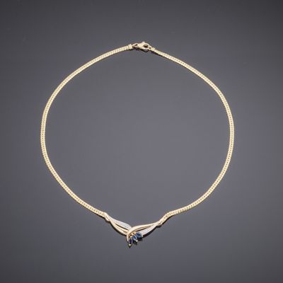 an 18k gold necklace with a blue sapphire and diamonds