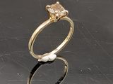 a gold ring with a pearl and a diamond on it