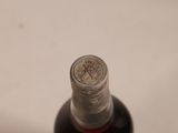 a bottle of liquor sitting on a white surface