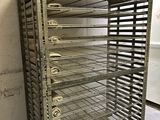a metal rack with a bunch of trays on it