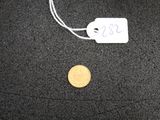 une pièce de monnaie posée par terre à côté d'un bout de papier
