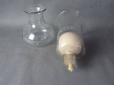 two empty glass vases sitting next to each other on a table