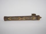 an old brass cigarette case with a design on it