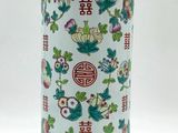 an image of a tall vase with flowers and birds on it