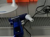 a blue blow dryer sitting on top of a metal counter