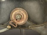 a close up of a helmet with a button on it