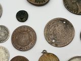 a lot of coins that are on a white surface
