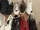 several pairs of shoes are lined up on a cardboard box