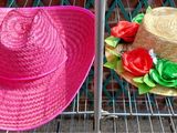two hats that are sitting on a rack