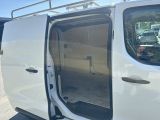 a white van with its door open and a man in the back seat