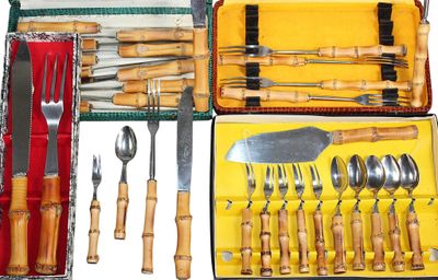 many different types of knives and spoons in a case