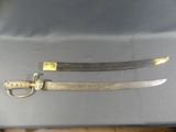 pair of old swords with gold handles on a table