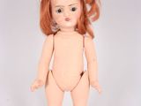 an image of a doll with red hair wearing a bodysuit