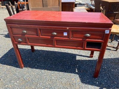 a red table with drawers and drawers on it