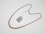 a close up of a gold chain with a tag on it
