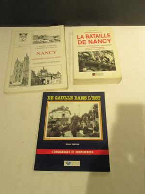 several books on a table with a clock and a clock on it