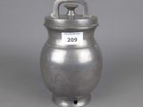 an old silver pot with a handle and a tag on it