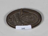 an image of a bronze coin with a leaf on it