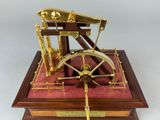 a model of a steam engine on a wooden base