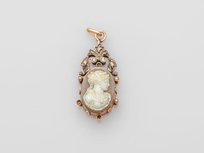 a gold and diamond cameo pendant with an image of a woman